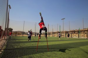 (180311) -- CAIRO, March 11, 2018 (Xinhua) -- Mahmoud Abdo (C), the founder and captain of the "Miracle Team", jumps skillfully upside down on his crutches to celebrate a goal during a training session in the pitch of El Salam youth center on the outskirts of the capital Cairo, Egypt on March 9, 2018. Carrying crutches, a group of 40 Egyptian one-legged soccer players have recently formed their "Miracle Team" that aspires to start league for disabled footballers in the country and dreams of joining the amputee football world cup one day. (Xinhua/Ahmed Gomaa)