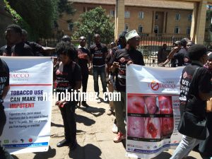 Tobacco control alliance members displays graphics images while singing sigara hatutaki tena(we don't want cigarettes again) outside Supreme Court. 